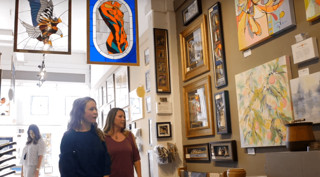 Two women walking around in the Stillwater Guild Gallery. 